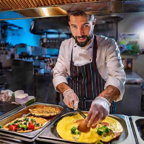 Chef preparing a custom omelet with fresh ingredients at Golden Corral.